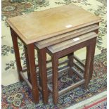 An oak nest of three tables, each with rectangular top, on square chamfered legs, 56cm wide.