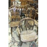 A set of six elm-seated wheel-back dining chairs, includes two carvers, a similar low chair and a