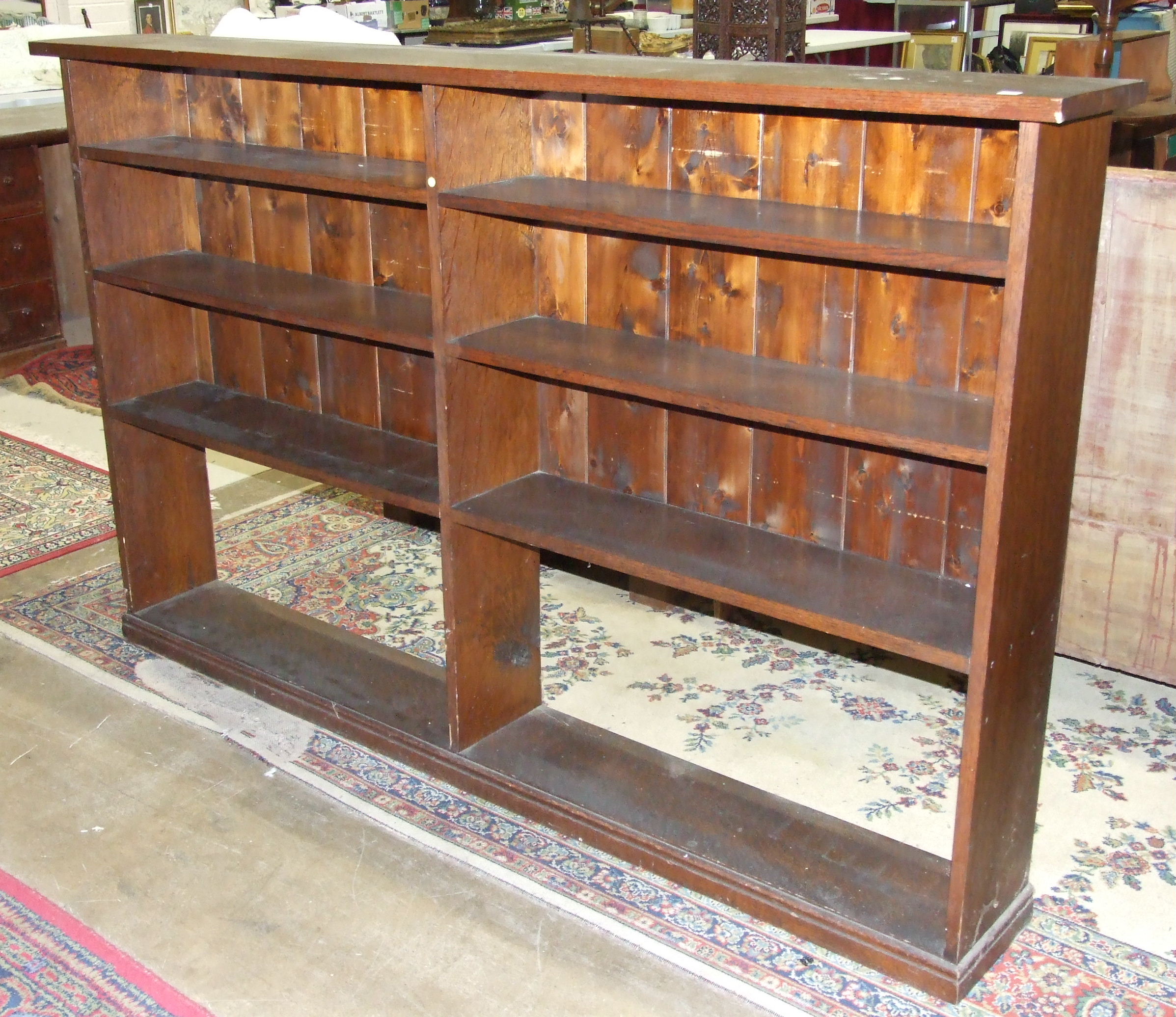 An oak floor-standing bookcase, 198cm wide, 123cm high.