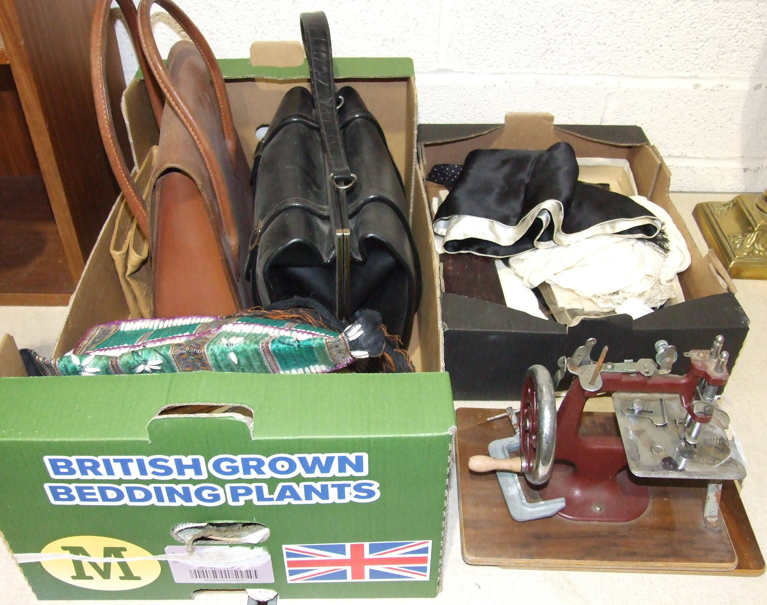 A tan leather handbag, a travelling double photo frame, a child's sewing machine and other items.