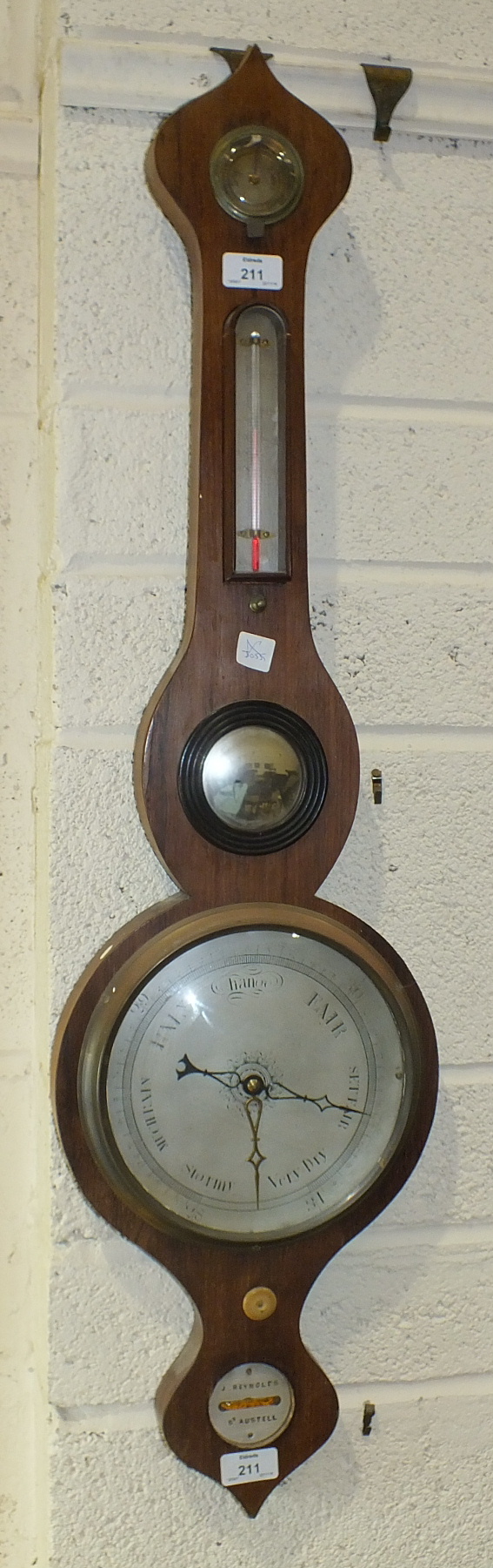 A mahogany wheel barometer, the level dial signed 'J Reynolds, St Austell', 96cm.