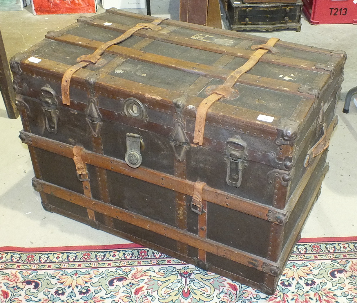 A wood and metal-bound canvas travelling trunk, 92cm wide.