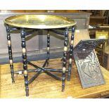 A brass Benares tray on folding wooden stand and a carved wood folding Koran stand, (2).