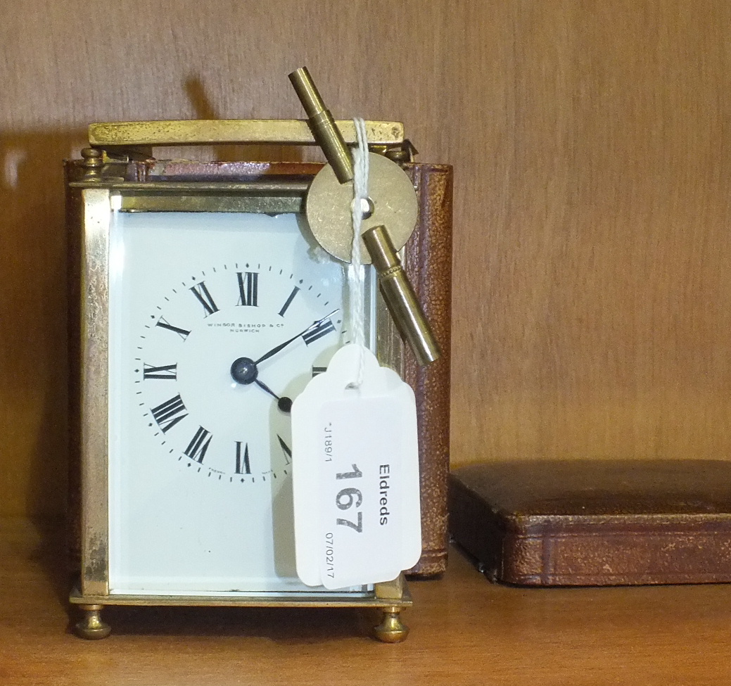A brass-cased carriage clock with carrying handle, the enamel dial marked 'Winsor, Bishop & Co,