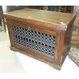 A hardwood television/hi-fi cabinet with drop-down pierced metal door, 89cm wide, 59cm high.