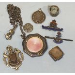 A small silver octagonal compact with enamelled lid, a silver violin brooch, two silver medallions