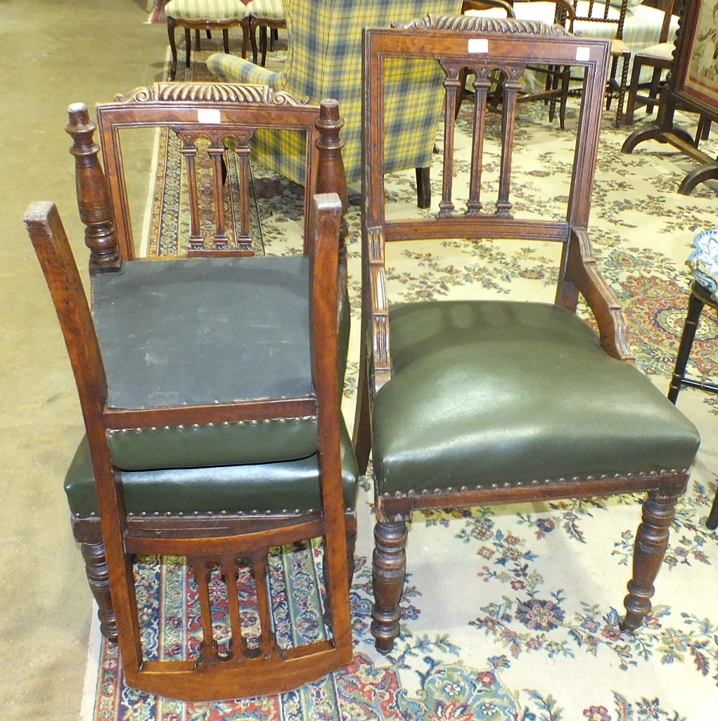 An Edwardian oak desk chair with upholstered seat, on turned front legs and a pair of matching