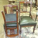 An Edwardian oak desk chair with upholstered seat, on turned front legs and a pair of matching