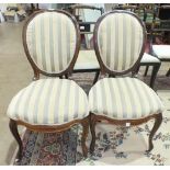 A pair of Victorian rosewood salon dining chairs with upholstered seat and back, on cabriole front