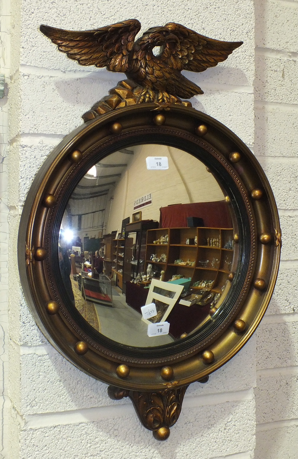 A reproduction Regency gilt-framed convex mirror, 70 x 46cm.