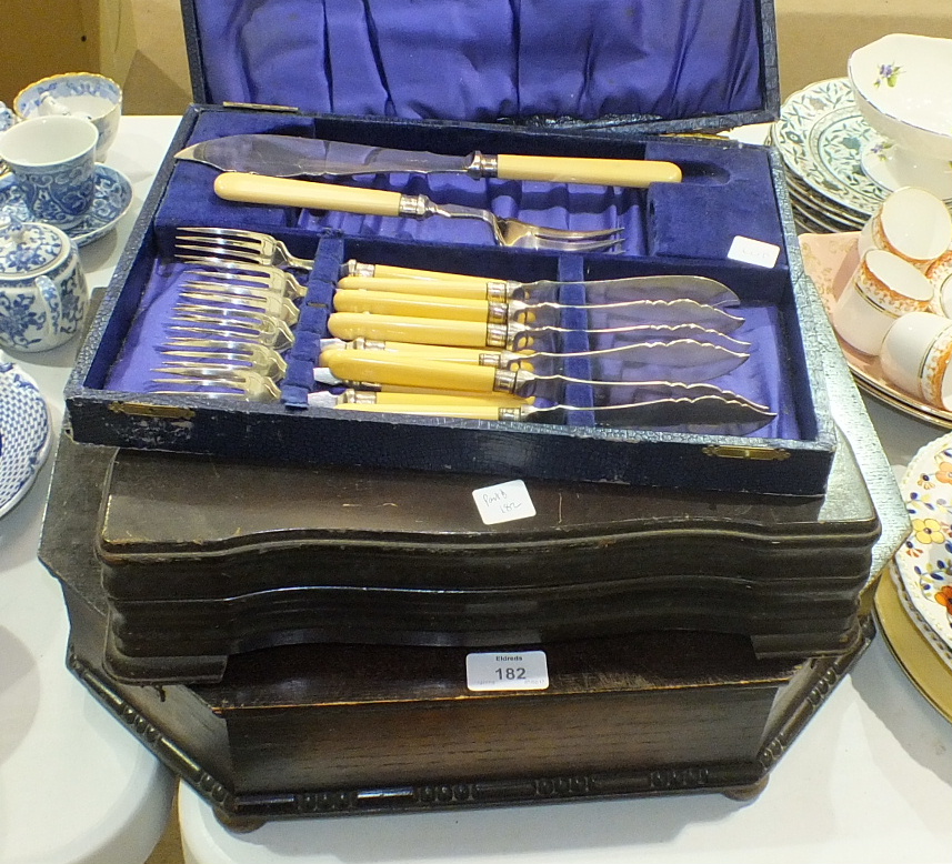 A canteen of plated cutlery contained in an oak fitted box, other cutlery, an inlaid walnut