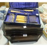 A canteen of plated cutlery contained in an oak fitted box, other cutlery, an inlaid walnut