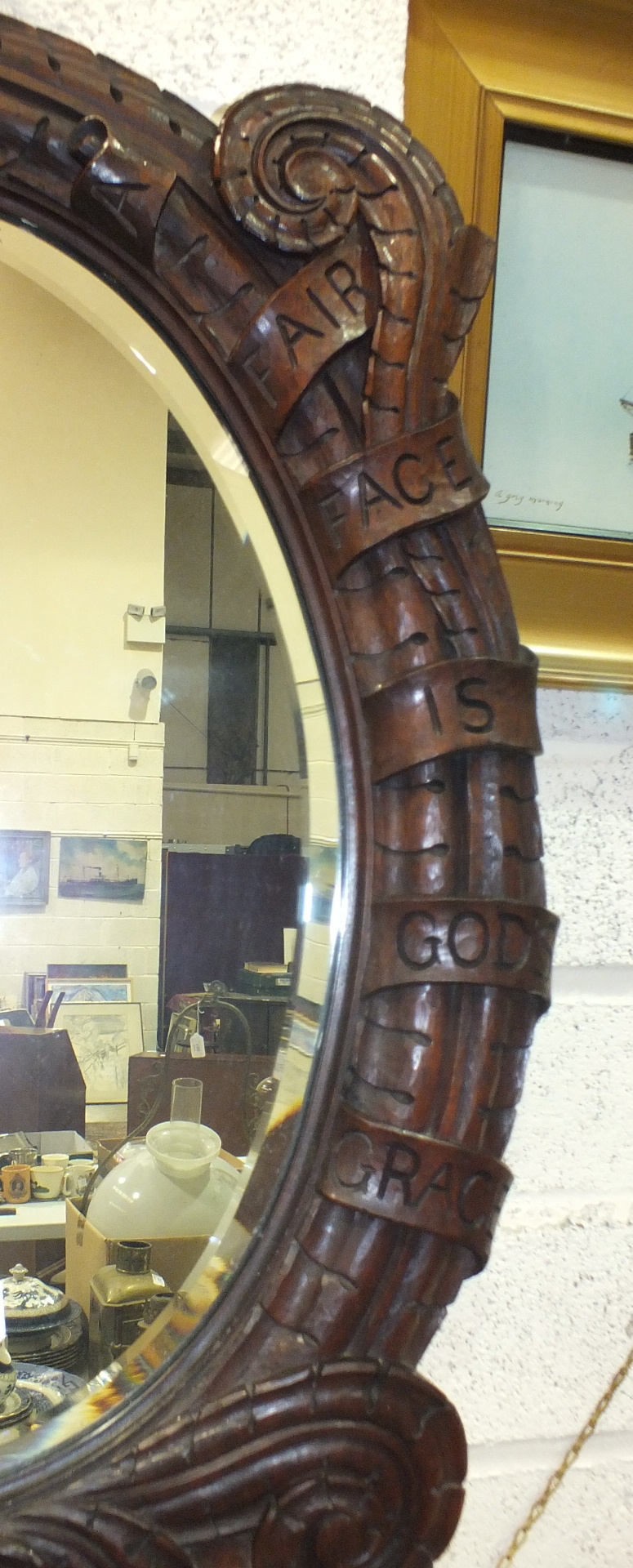 An oval bevelled mirror plate within a hardwood frame carved with a Peacock and engraved 'A Fair - Image 2 of 2
