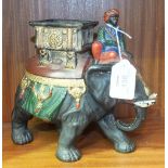 A pottery model of an elephant with mahout and detachable howdah lid, with overall painted