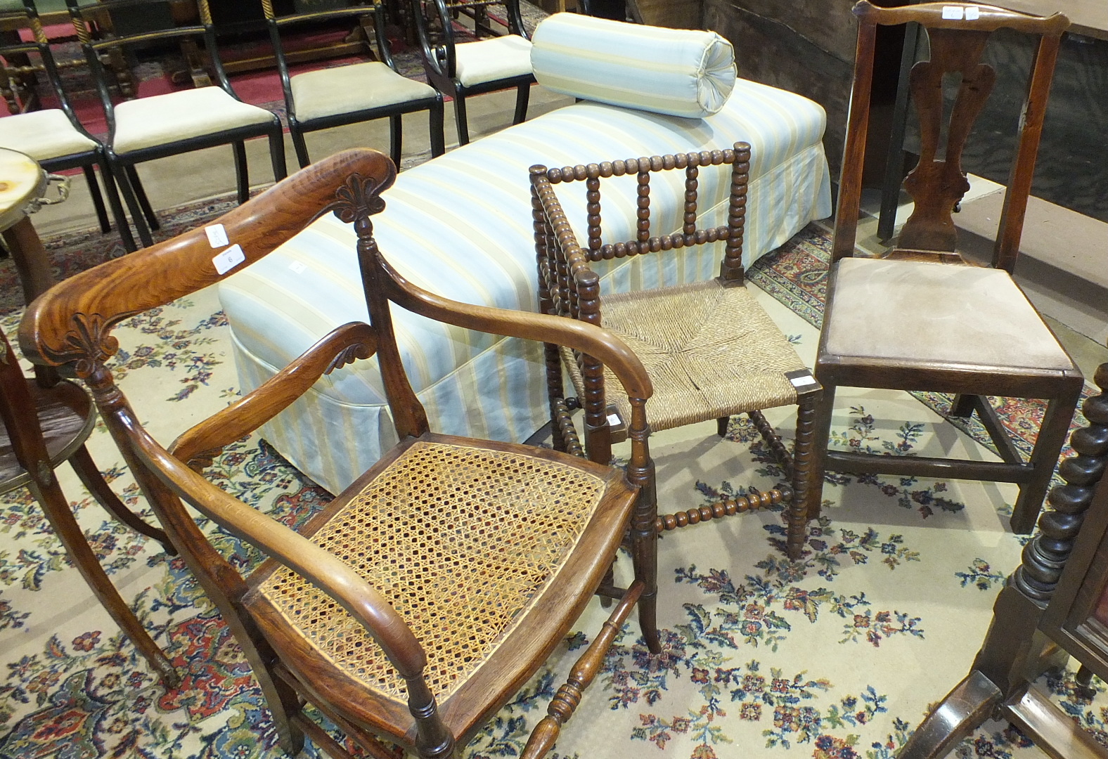 A stained wood bobbin-turned rush-seated corner chair, a Victorian cane-seated armchair and a