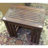 A teak nest of three tables with plaque 'Made from Teakwood taken from the RMS Mauritania by the