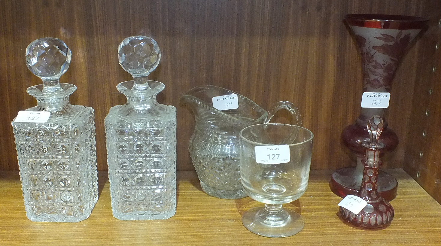 A pair of cut-glass decanters and stoppers, 23cm high, a glass rummer, a cut-glass jug, a ruby and