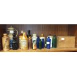 A collection of stoneware and glass bottles, including two Doulton Lambeth sheered-neck bottles