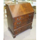 A reproduction mahogany Georgian-style bureau, the fall-front above four graduated long drawers,