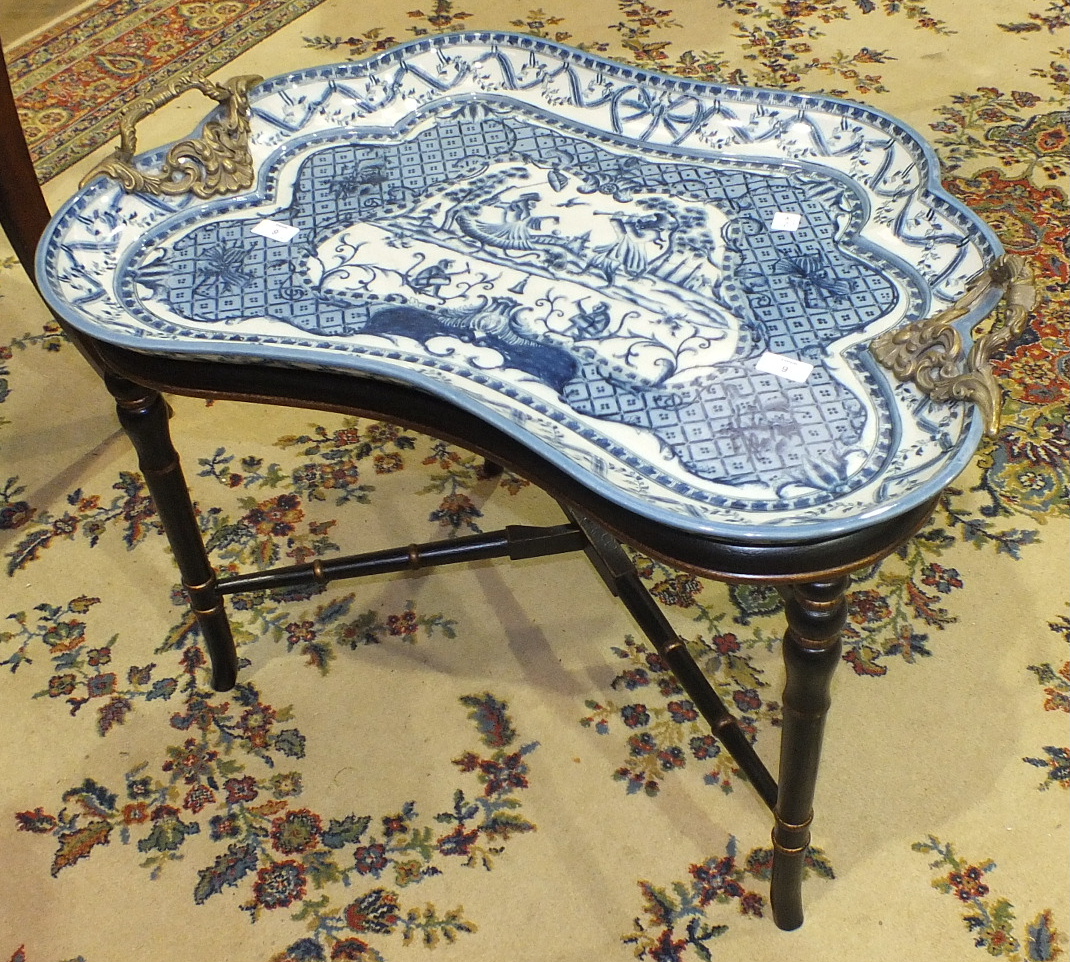 A similar tray and stand, the tray decorated blue and white with a monkey in Regency attire