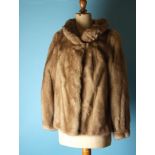 A blond mink jacket with padded collar and long sleeves, by Edelson.