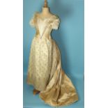 A Victorian taupe silk two-piece evening gown c1860's, the boned bodice with V-neckline and waist,