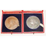 A Queen Victoria 1837-1897 silver medallion and a similar bronze medallion, both cased, (2).