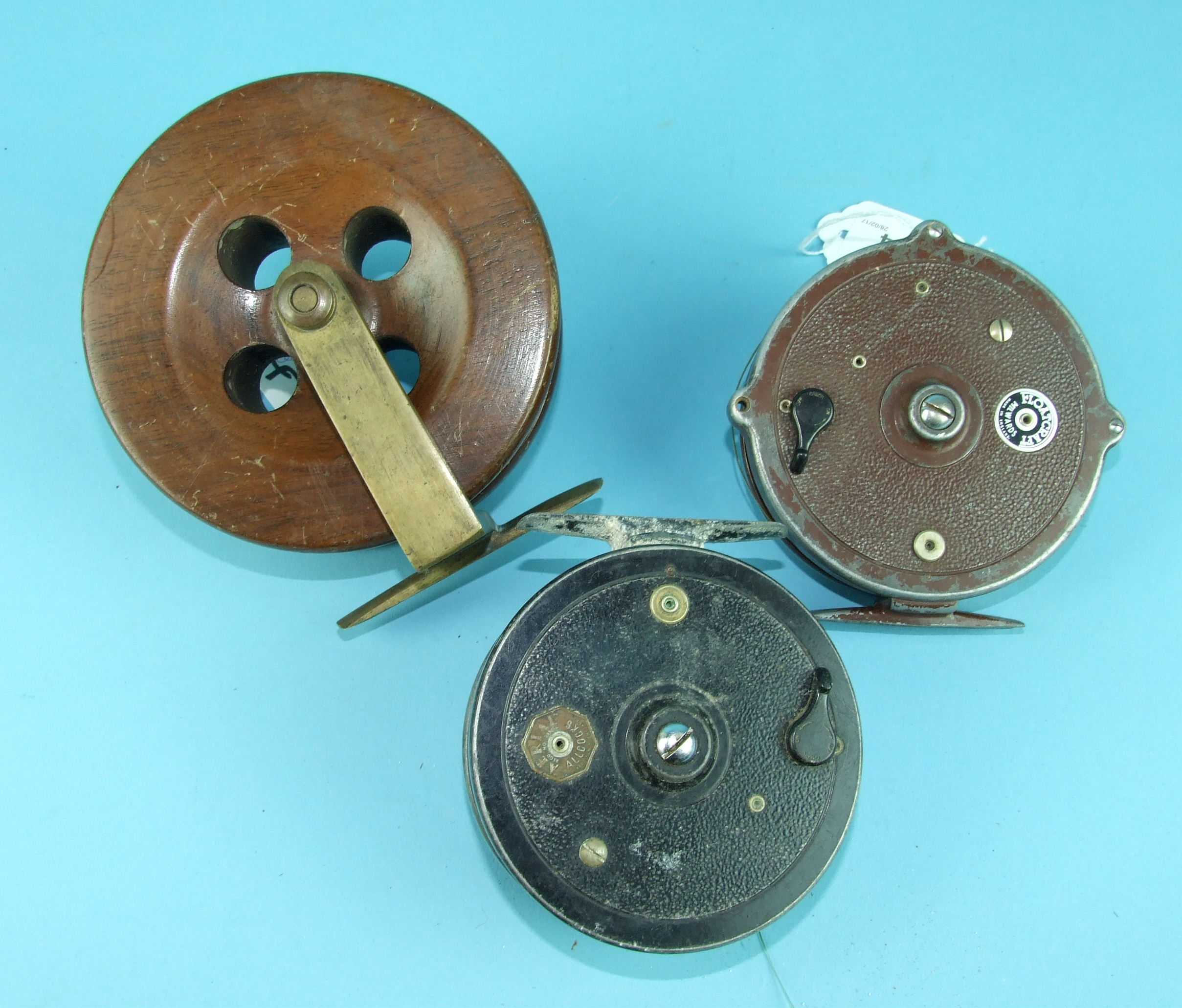 An Allcocks "Arial" reel, (some corrosion), a Milwards Floatcraft reel finished brown and a wooden