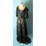 A Victorian black evening dress, the satin bodice with low neckline, (altered) and puff sleeves