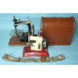 A cased miniature sewing machine by 'LEAD', (handle and catches of case missing), a later "Little