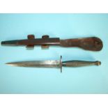 A WWII second pattern Fairbairn-Sykes fighting knife by Wilkinson, the black handle with 2" straight