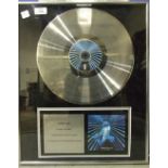 Jamiroquai, a limited edition platinum award for the album 'Synkronized', 102 x 46cm, another for 'A