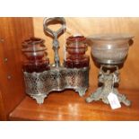 A pair of ruby glass pickle jars and covers in a plated pierced stand, 26cm high overall and a glass