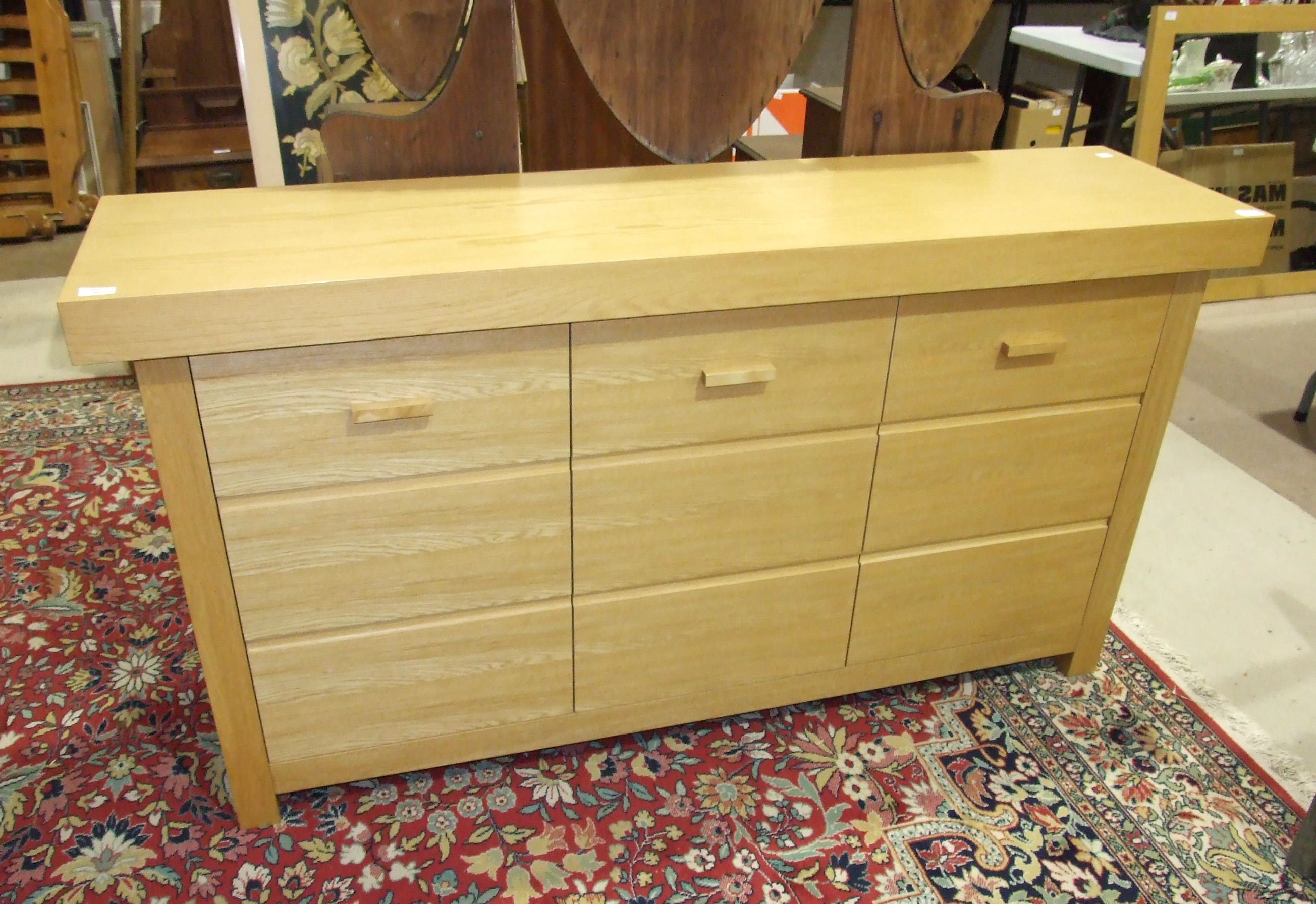 A modern oak sideboard of plain design.