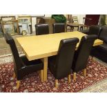 A modern oak dining table and six chairs.