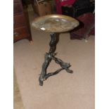 An unusual occasional table with brass tray top, on tripod support constructed from antelope