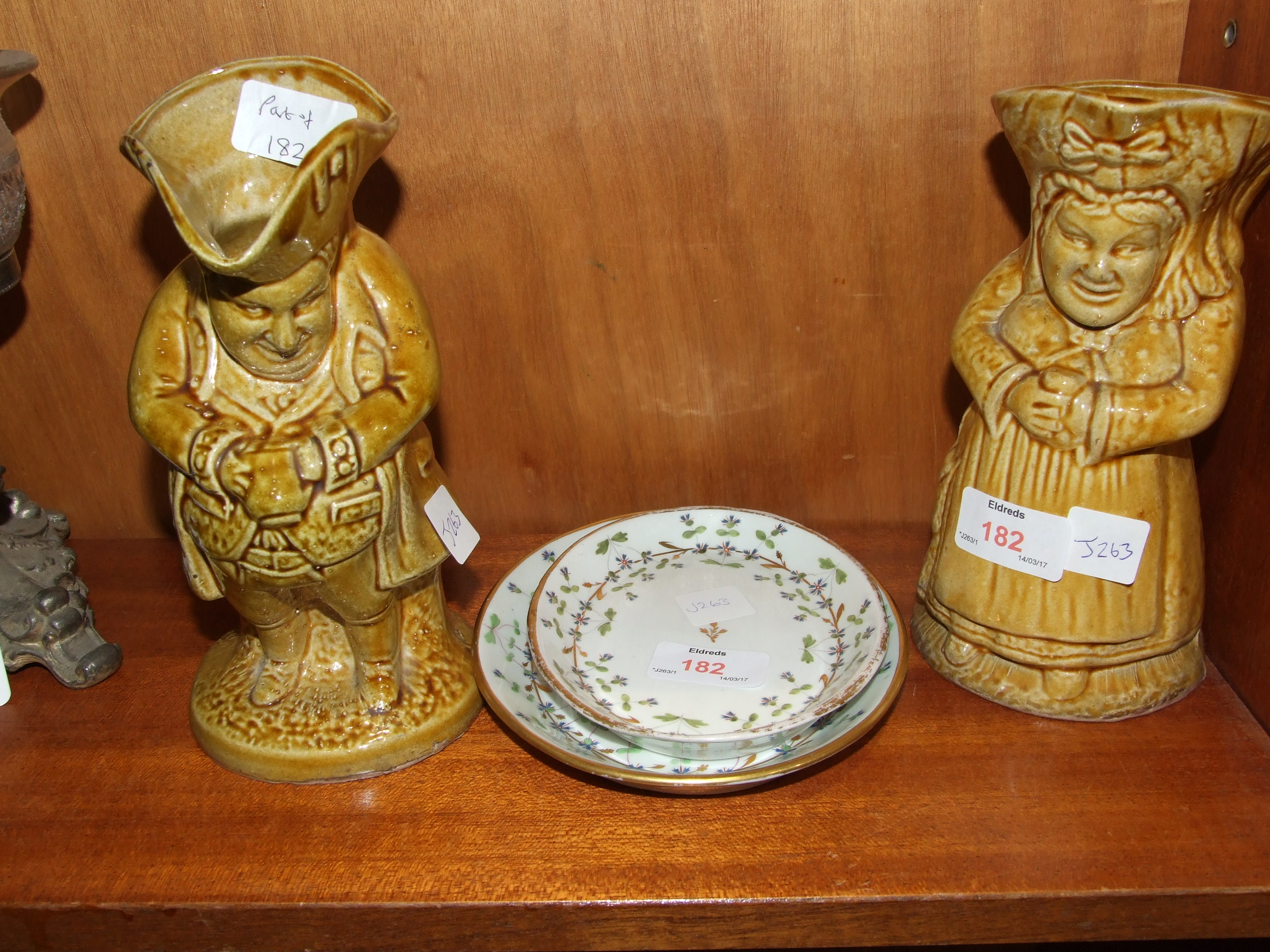 Two salt glaze Toby jugs, 20cm high and two English ceramic oval trays with floral decoration, 17