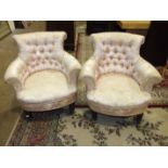 A pair of Late-Victorian button-back tub armchairs on short turned legs with castors.