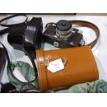 An Olympus OM10 camera, a Minolta Hi-Matic 7 camera and a pair of Simor binoculars, (12x50 extra