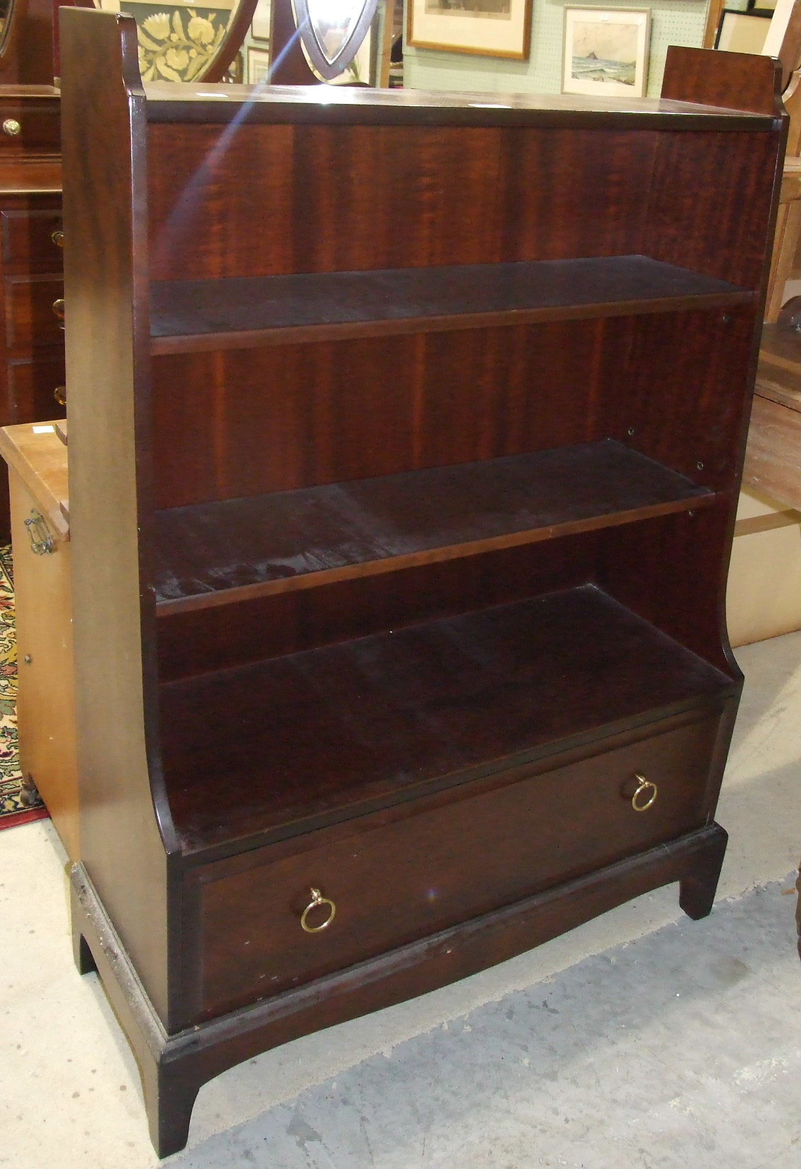 A Stag bookcase and two dressing table mirrors, (3).