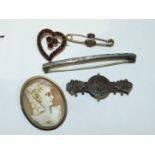 A small heart shaped brooch set garnets, a silver bar brooch, a Victorian silver brooch, a cameo