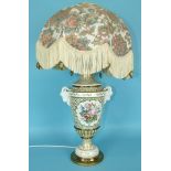 A large 19th century French porcelain vase decorated with panels of flowers on a white and gilt