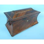 An early-19th century rosewood sarcophagus-shaped tea caddy with wood ring handles, fitted with
