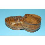 A carved root wood inkwell in the form of a boot, the hinged lid revealing a glass lined inkwell,