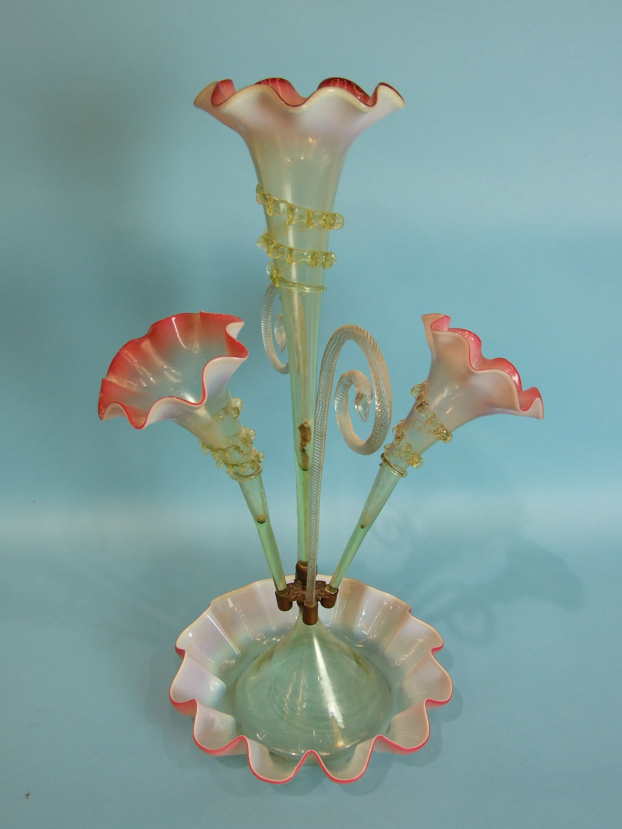 A 19th century Vaseline glass epergne of pale green and red glass, comprising three flutes and two