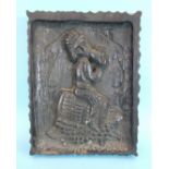 An antique carved hardwood panel, relief-carved with a figure seated on a barrel drinking from a