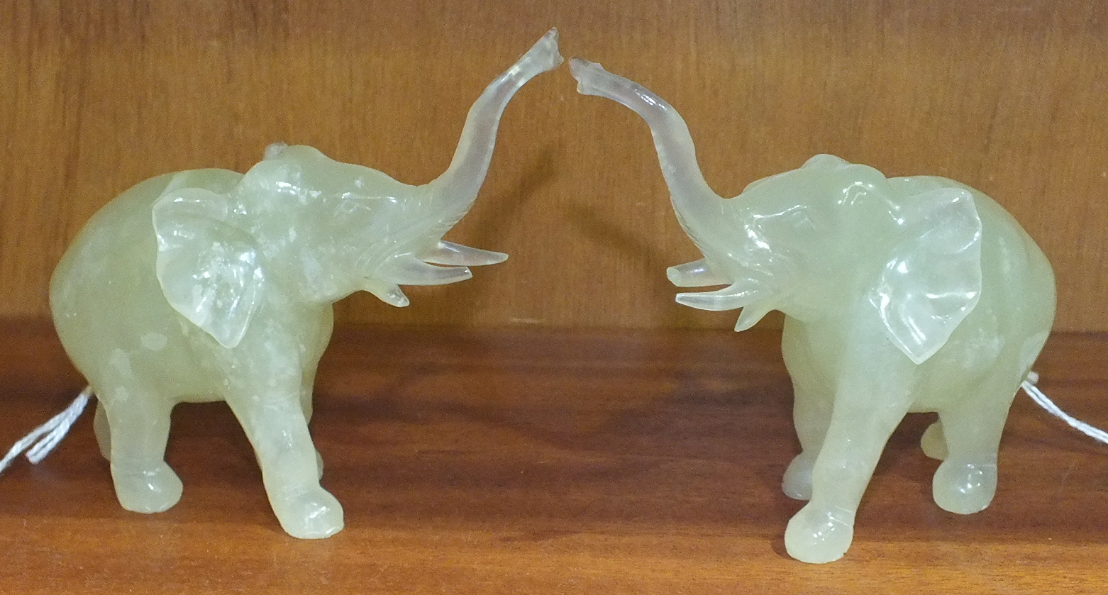 A pair of 20th century Chinese carved pale hardstone figures of standing elephants, 12cm long, (