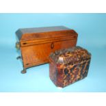 A bird's-eye maple tea caddy of sarcophagus shape, fitted with two canisters and mixing bowl