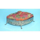 A lozenge-shaped jewellery box with coloured raffia-work lid and embossed body, on cabriole feet,