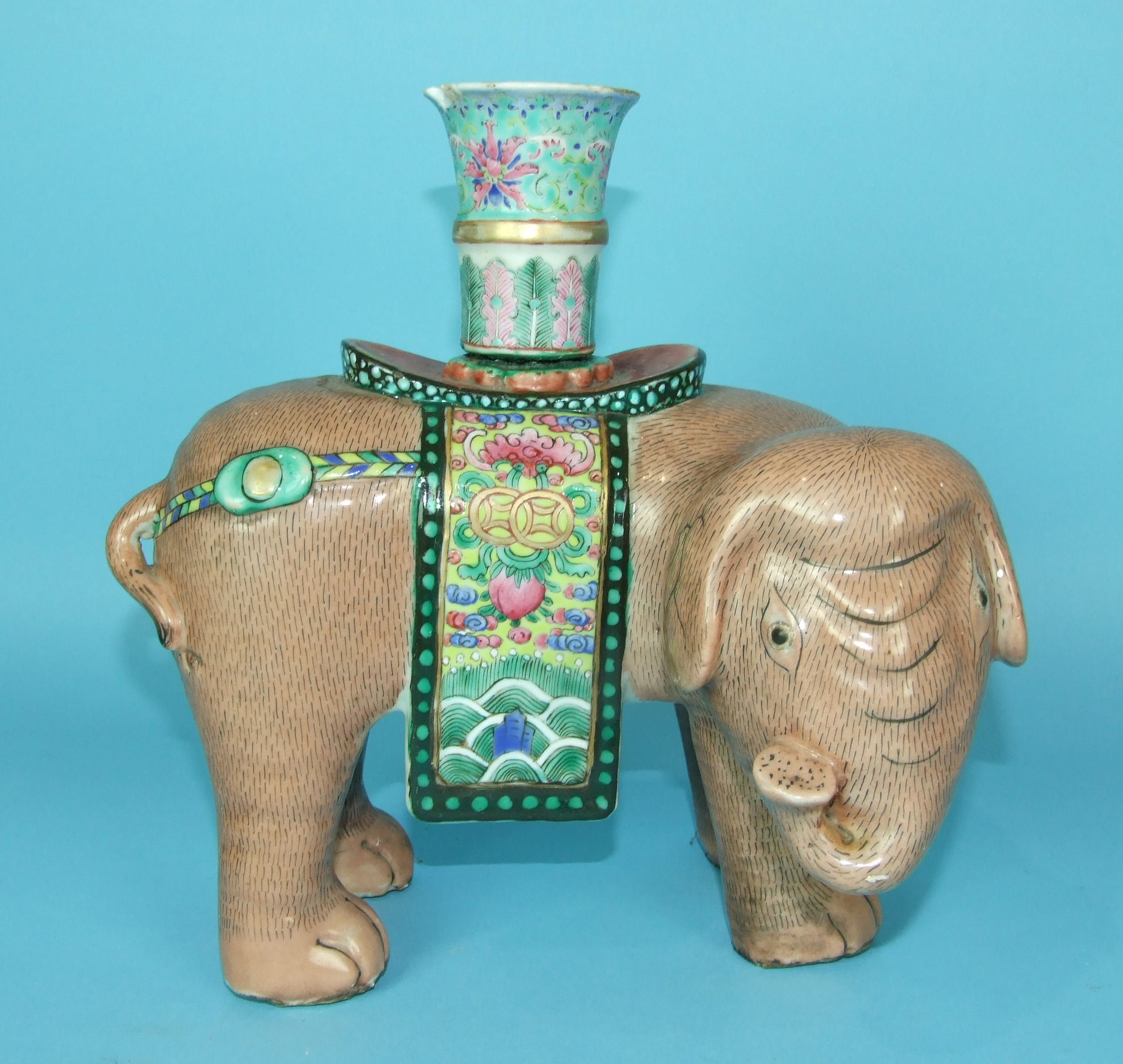 A 19th century Chinese famille rose figure of a standing elephant with a vase on his back, vase